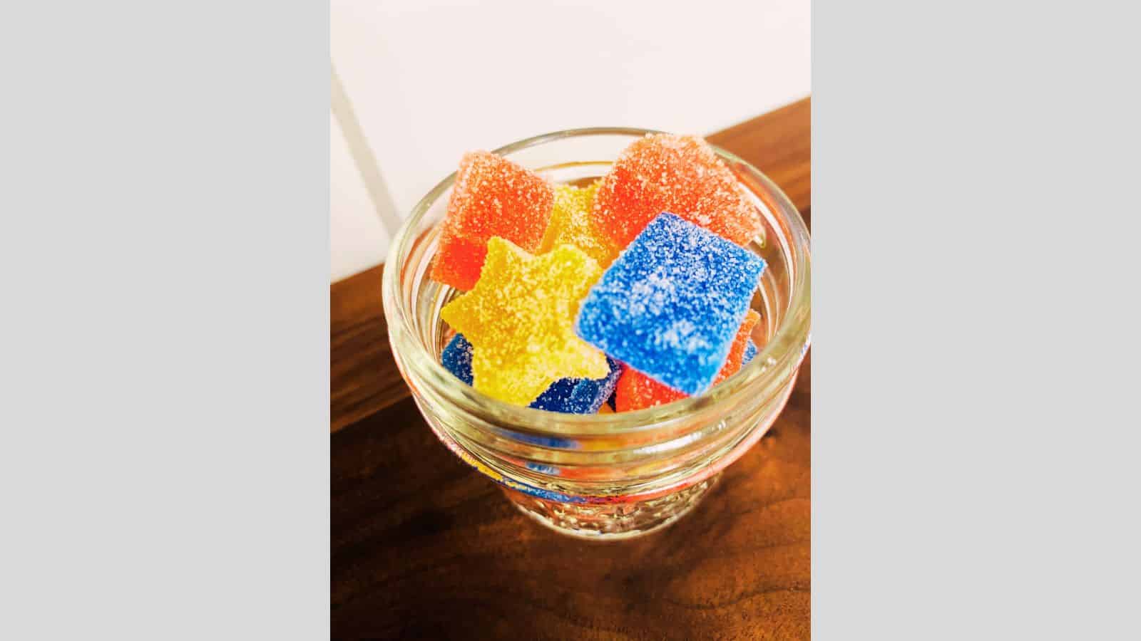 Colorful gumdrops in glass bowl.