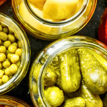 A group of jars of pickles and cucumbers.