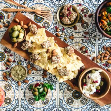 A tray of nuts and a container of natural delights.