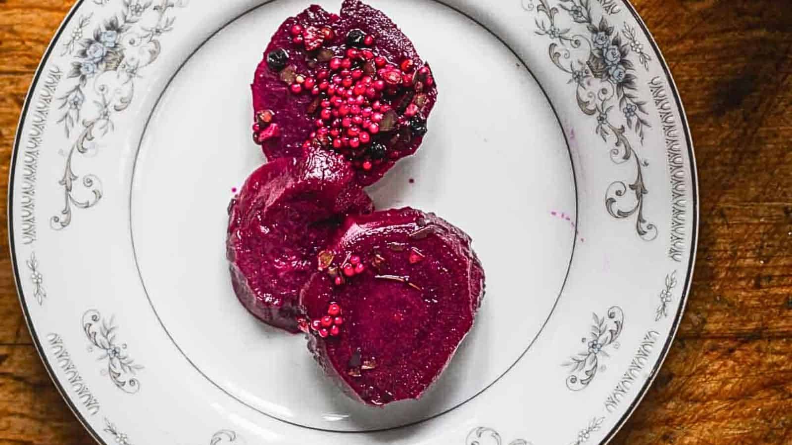 Beets with pomegranate seeds on a plate.