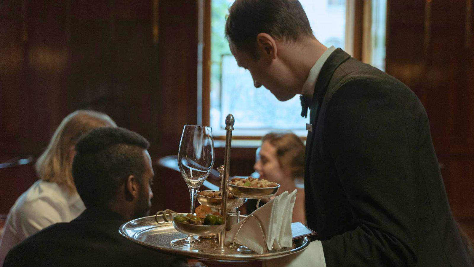 Waiter serving drinks to a group of people