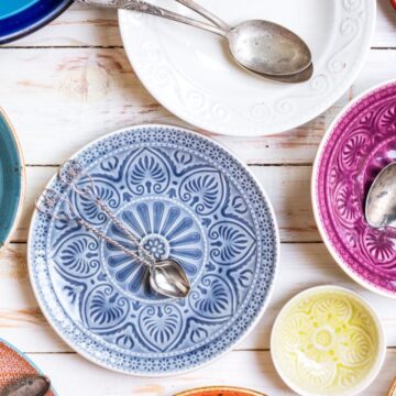 Vintage dishes with spoons on top placed on table