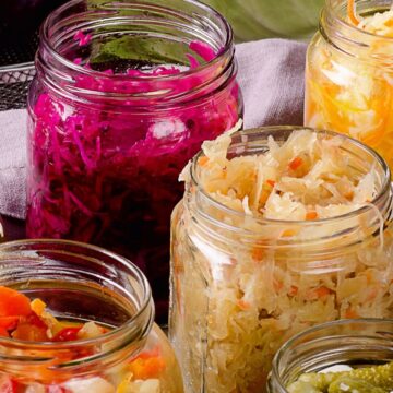 Assorted jars of pickles and other foods on a table