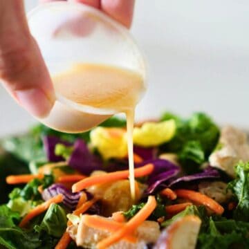Dressing being poured on salad