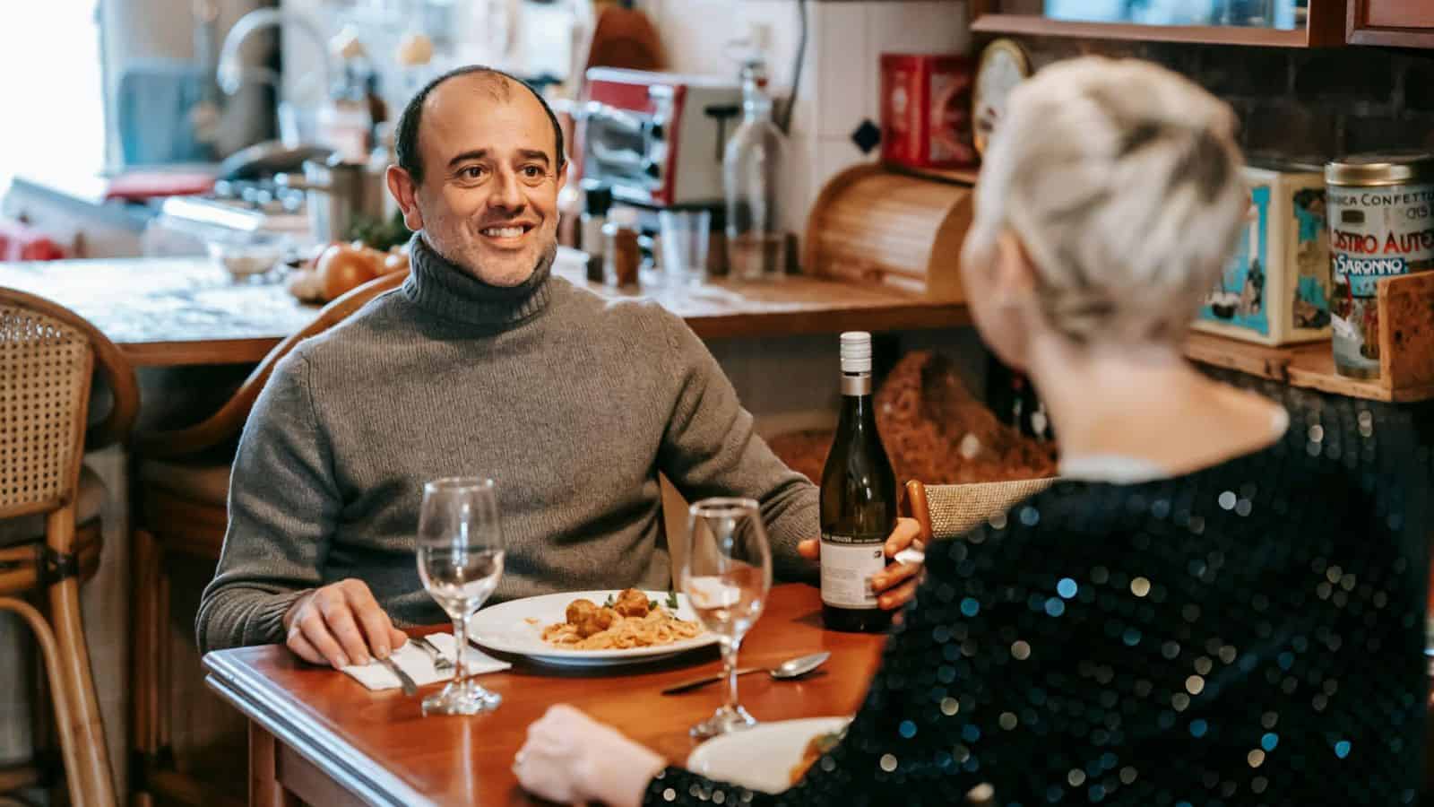 A couple on a spaghetti and wine date