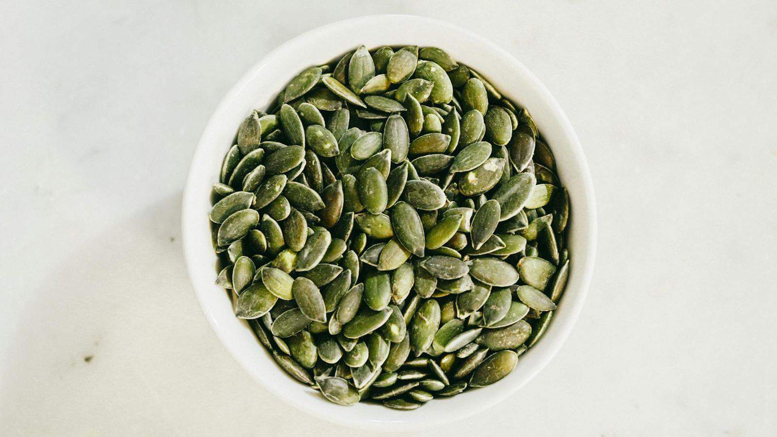 Aerial view of a bowl of pumpkin seeds