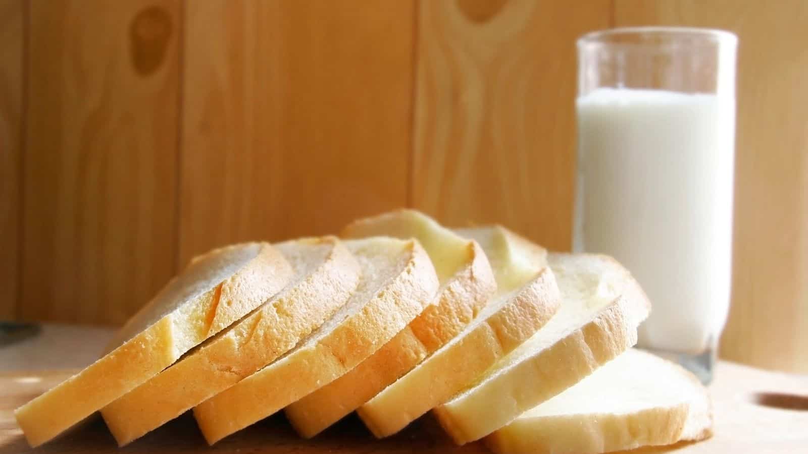 Pieces of bread and a glass of milk on a table