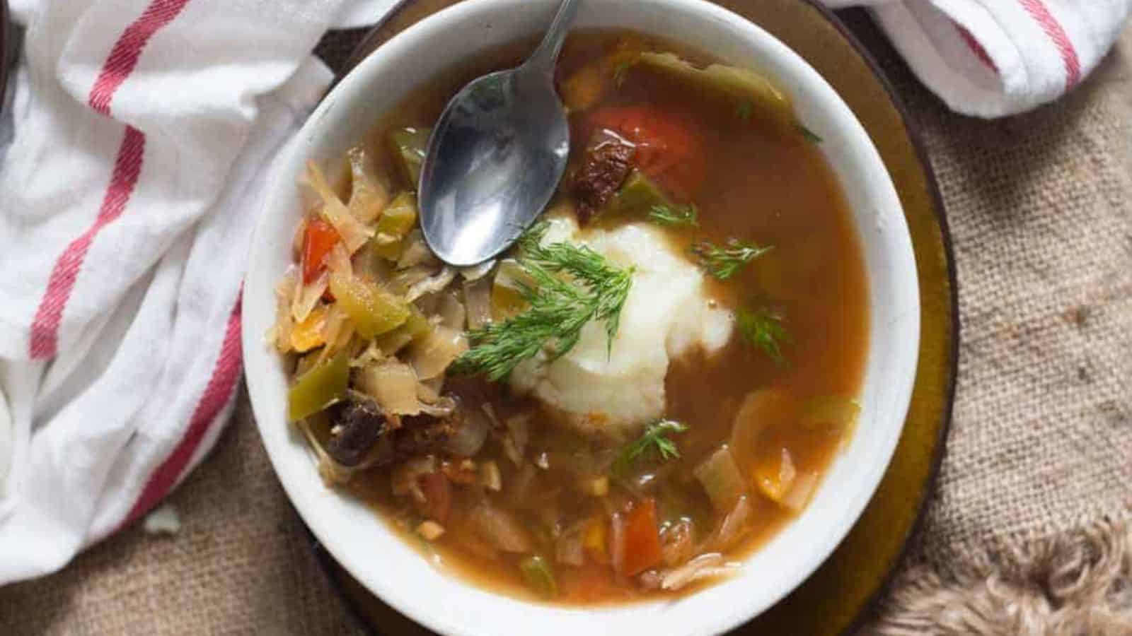 A bowl of soup with a spoon in it.