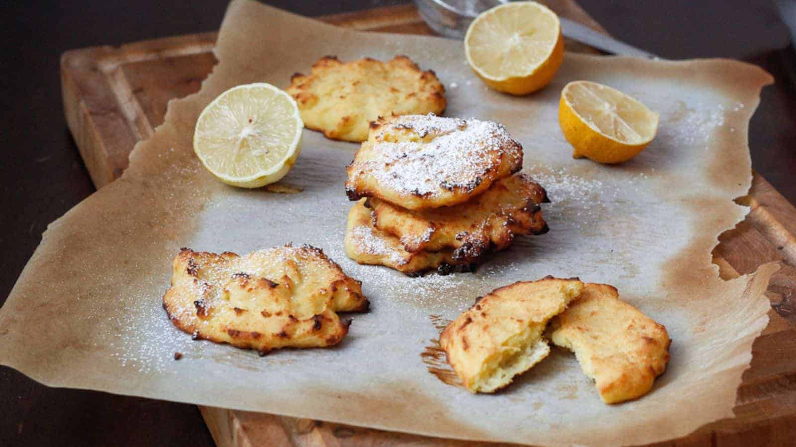 Pancakes on a parchment paper on cutting board.