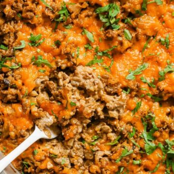 Creamy ground beef skillet with cauliflower rice with a wooden spoon.