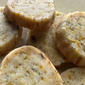 Closeup image of a stacked dandelion shortbread cookies.
