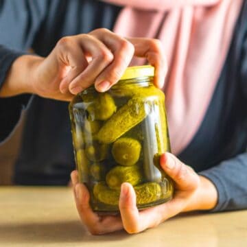 Person trying to open the lid of a jar