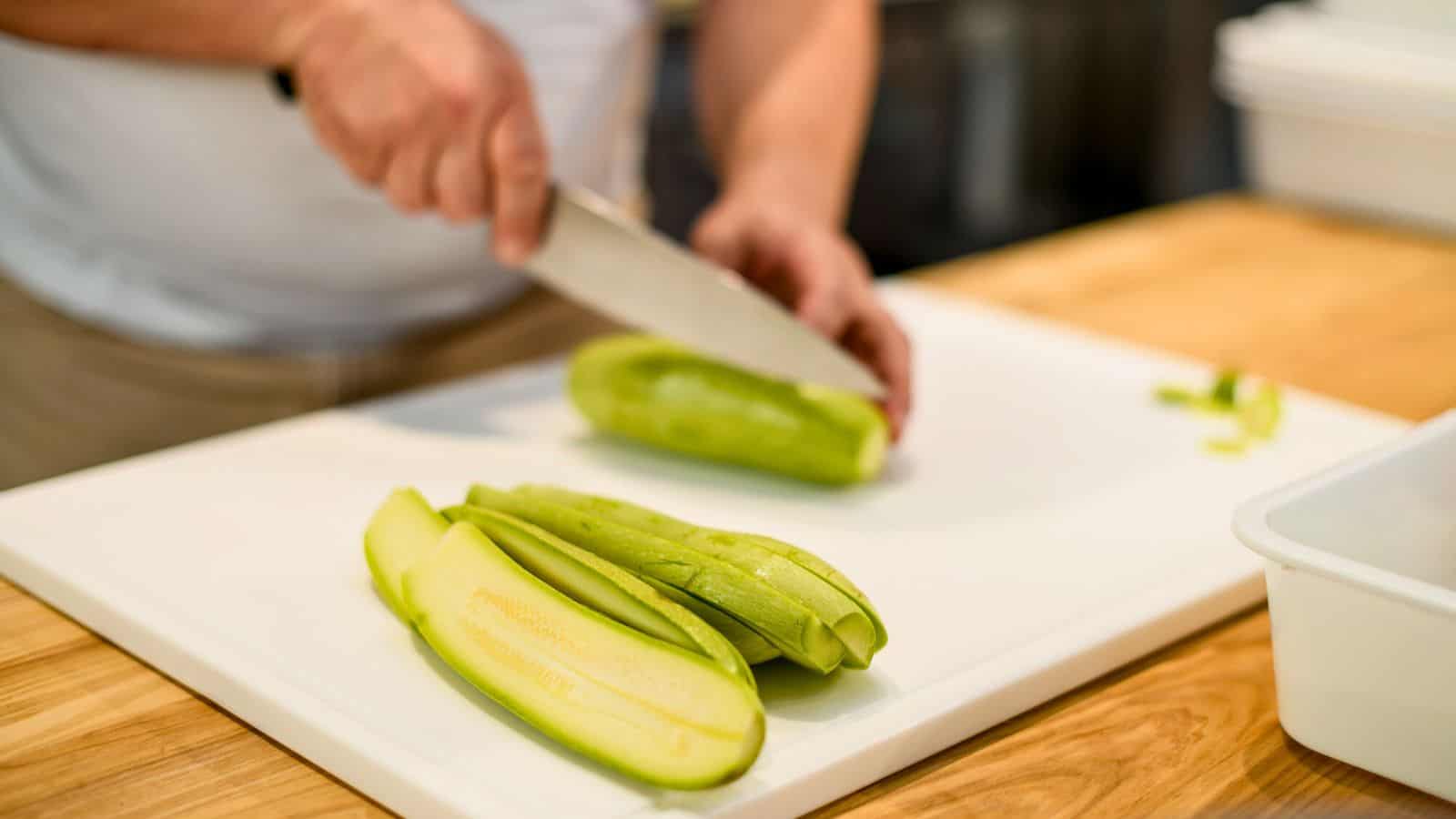 Person slicing zucchinis