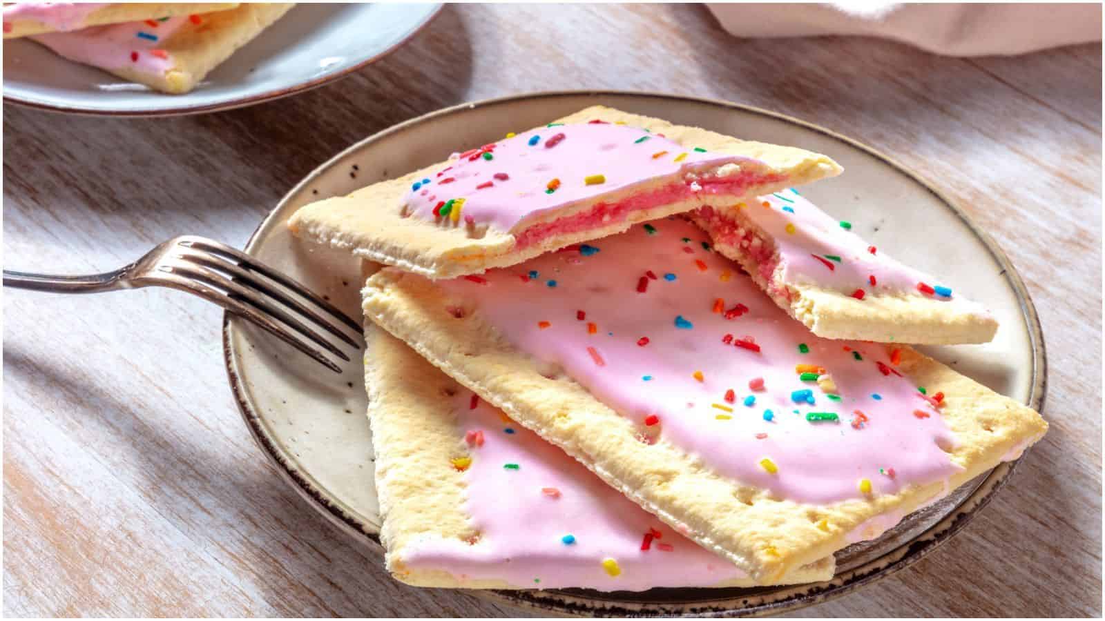 Strawberry pop tarts placed on a plate with a fork on the side