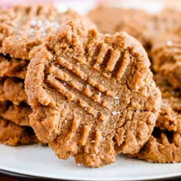 A stack of keto peanut butter cookies sprinkled with salt.