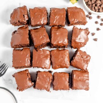 Sliced zucchini brownies on a white table.