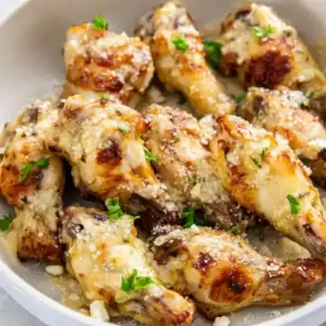 Air Fryer Garlic Parmesan Wings in a white bowl with parsley.