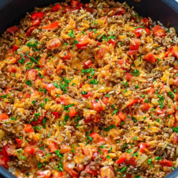 A skillet filled with beef, rice and vegetables.