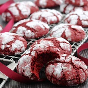 A cooling rack with red velvet crinkle cookies.