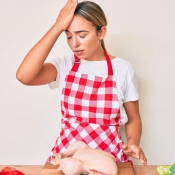 Woman with an apron facepalming herself