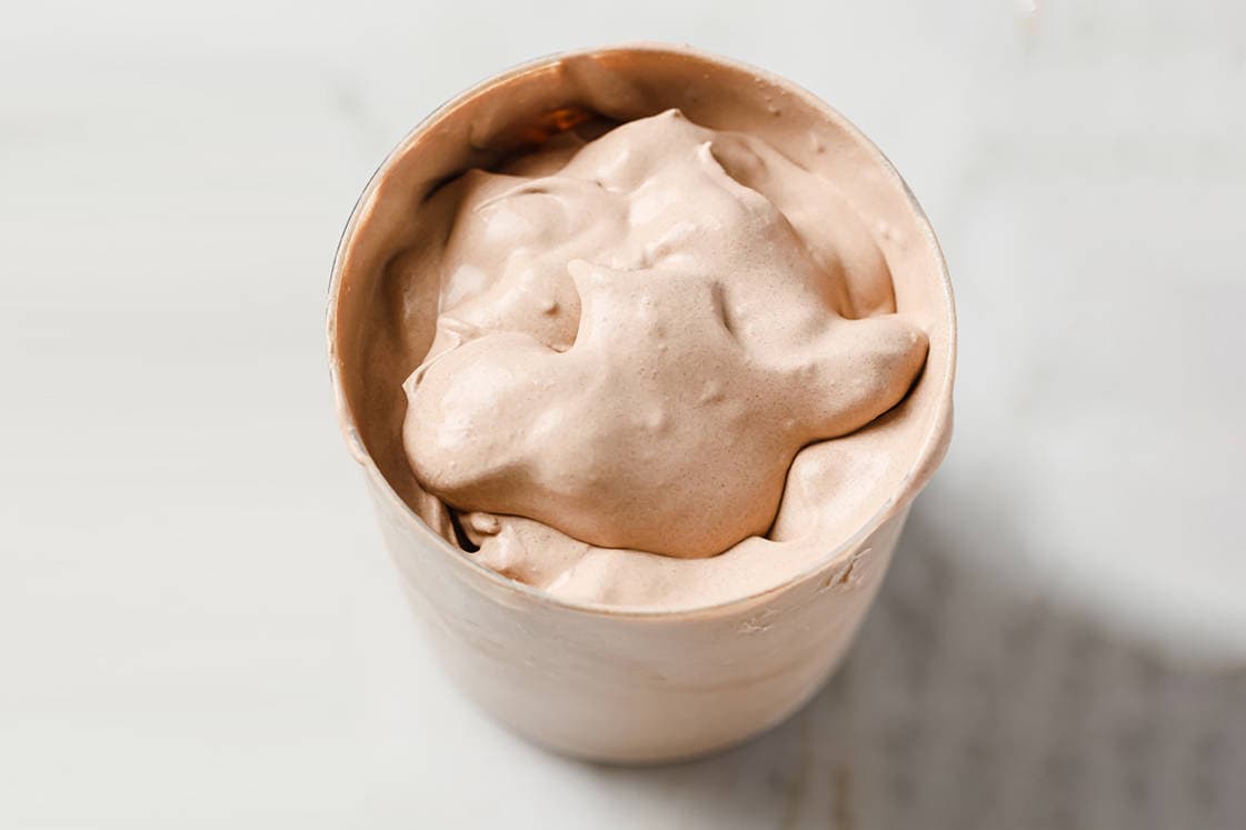 A glass of keto frosty on a countertop.