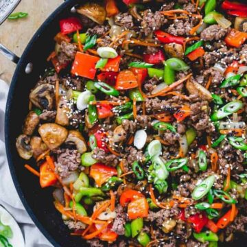 Ground beef stir fry in a skillet.
