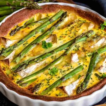 A white casserole with asparagus quiche.