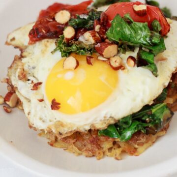 potato latke with egg on white plate