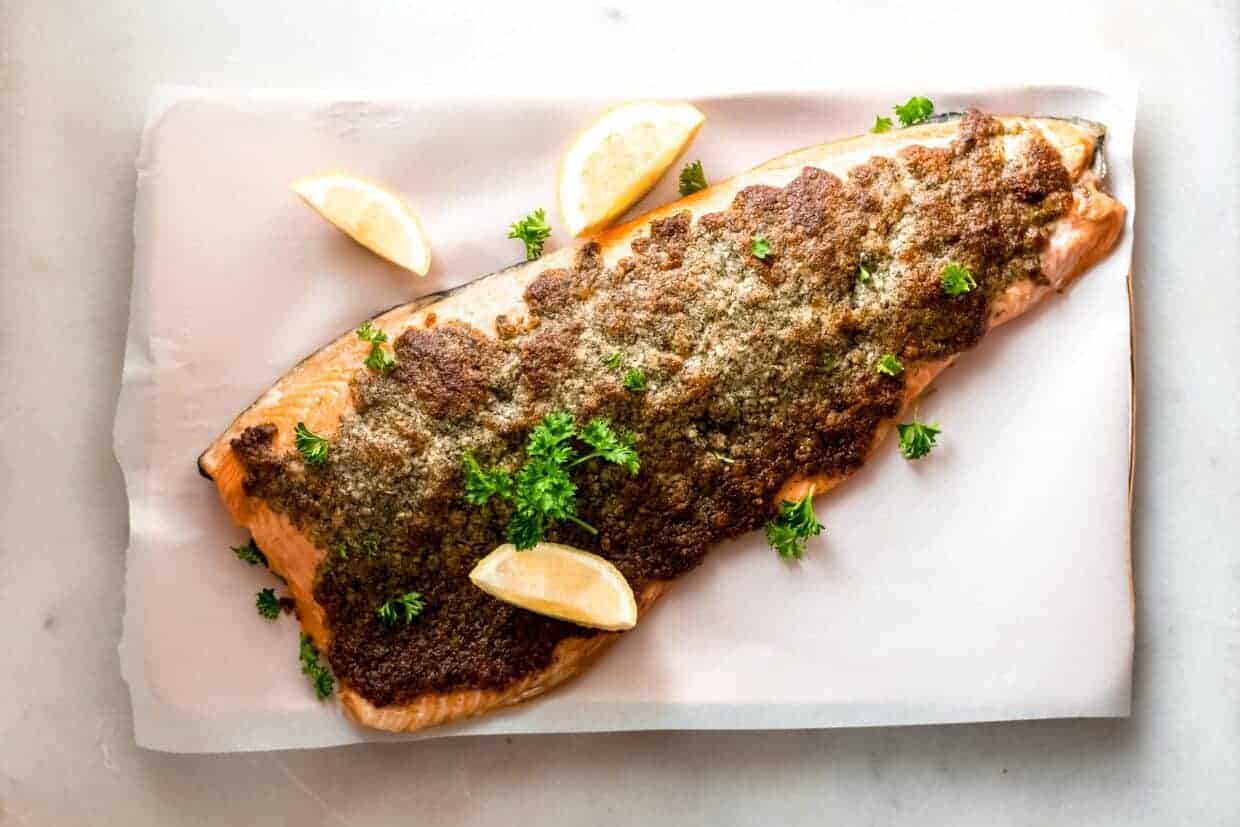 Keto baked parmesan salmon on foil on a baking sheet.