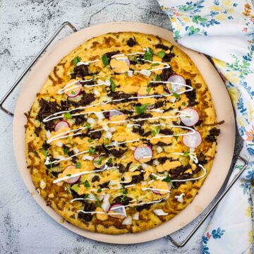 Birria Pizza on a pizza stone.
