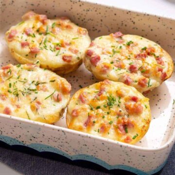 Four twice baked potatoes in a small baking dish.