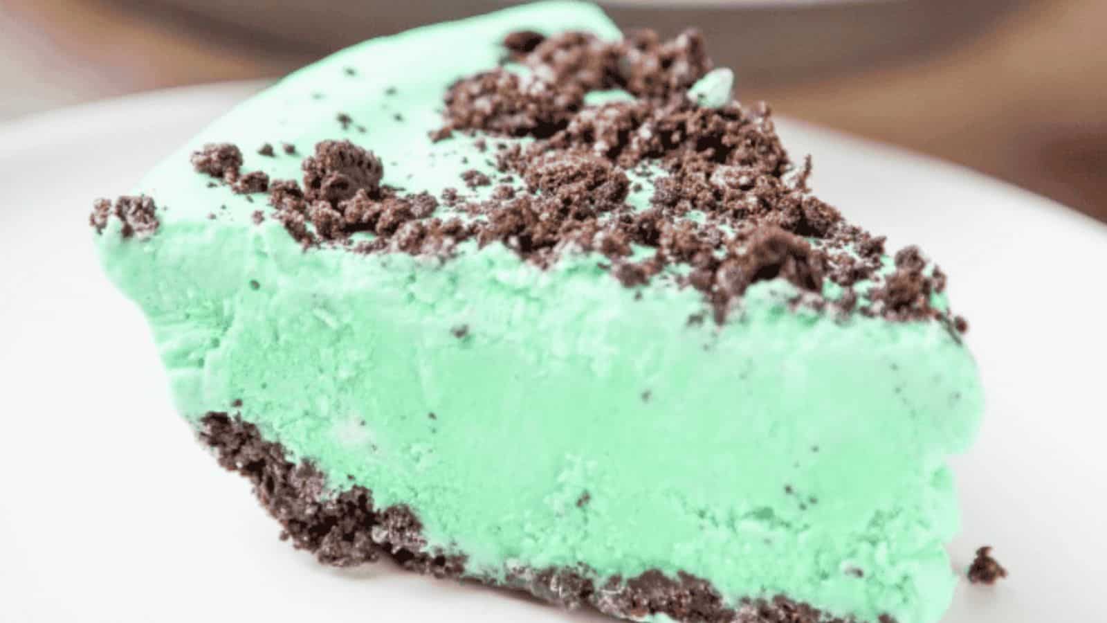 A mint pie inside an oreo crust topped with oreo crumbs.