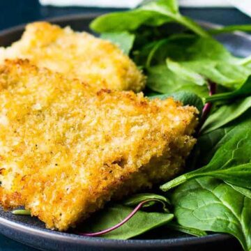 For those lazy dinners where making yourself something special feels like a secret treat, enjoy a plate of two pieces of breaded and fried fish alongside fresh spinach leaves. It’s the perfect meal to secretly brag about mastering simplicity with style.