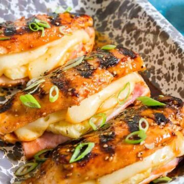 Grilled chicken breasts stuffed with ham, pineapple and Jarlsberg cheese garnished with green onion.