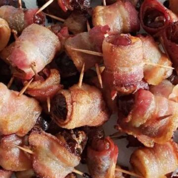 Image shows an overhead shot closeup of Bacon Wrapped Dates.