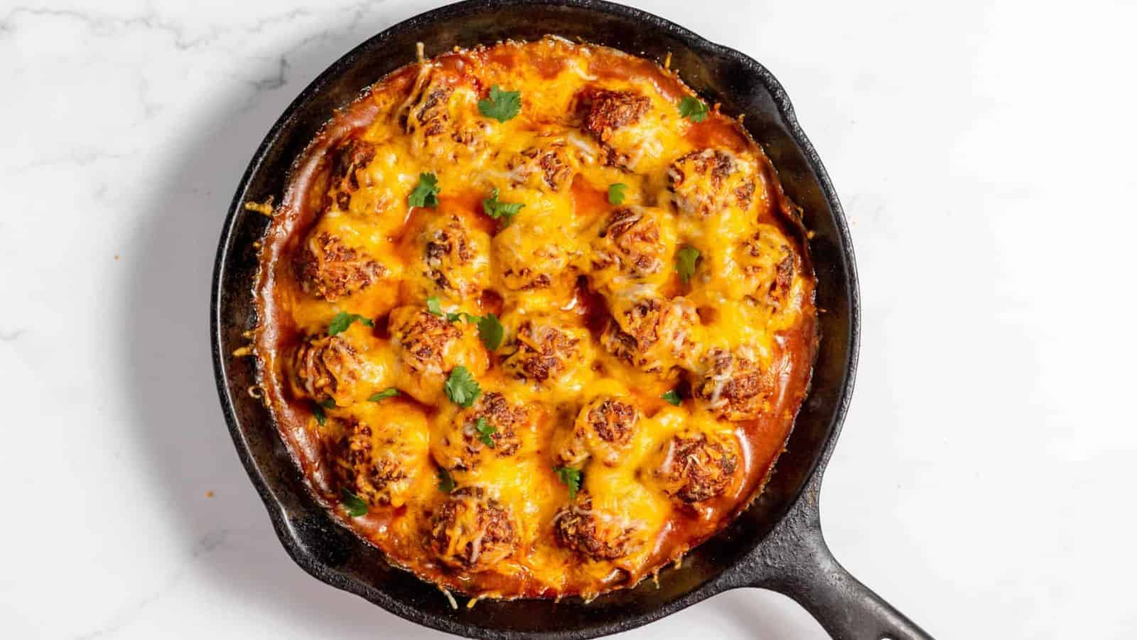 Cheesy mexican meatballs in a skillet.