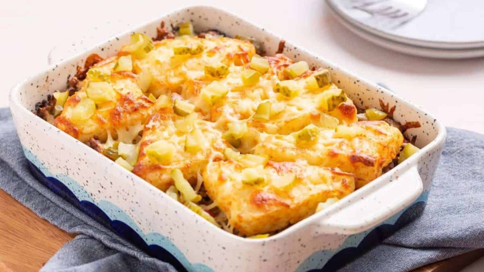 Cheesy hashbrown topped casserole in baking pan.