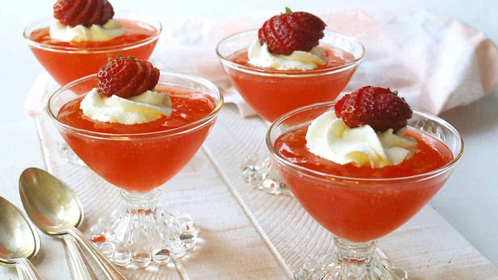 Strawberry gelatin dessert in glass dessert dishes.