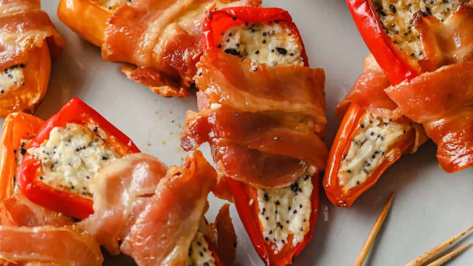 A plate of bacon wrapped mini peppers.