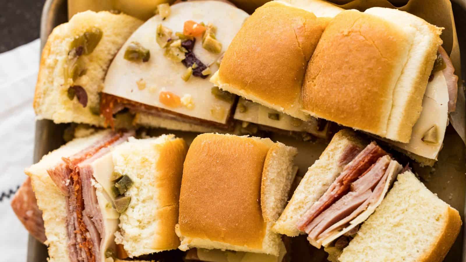 Ham and cheese sandwiches in a pan with a napkin.