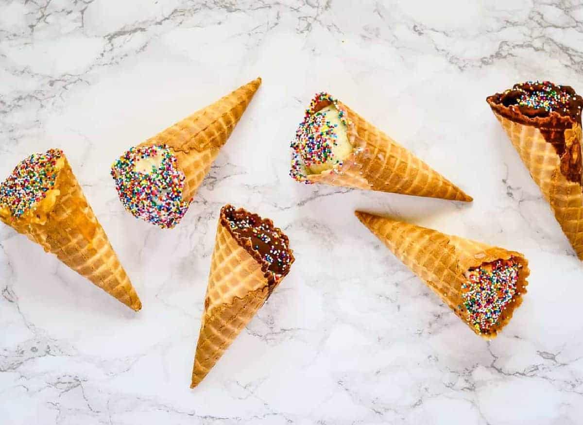 Overhead shot of 6 cones, two in chocolate, two peanut butter, two vanilla.