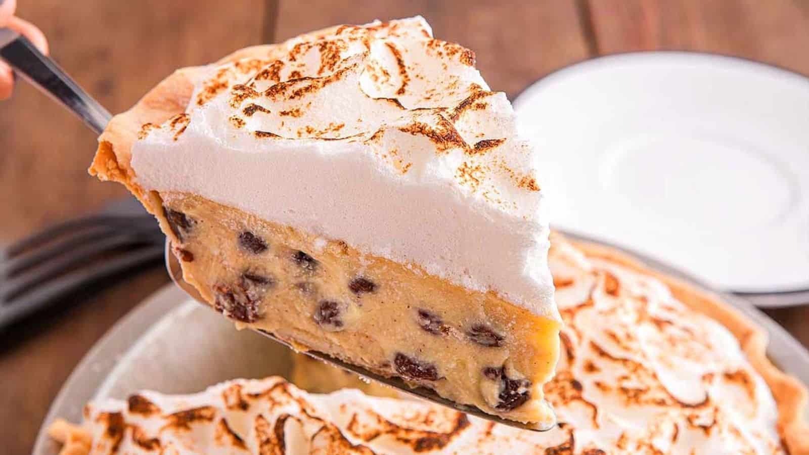 A slice of raisin pie with cream on top.