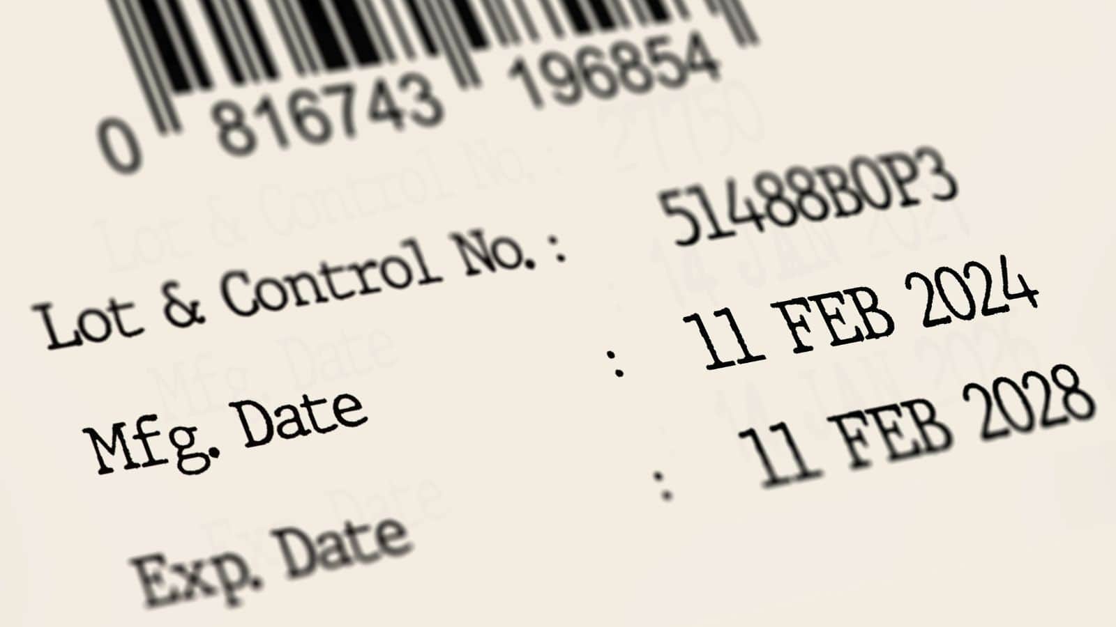 A close-up of a printed label showing a barcode, lot and control number, manufacturing date of 11 FEB 2024, and expiration date of 11 FEB 2028. Some text and numbers are slightly out of focus.
