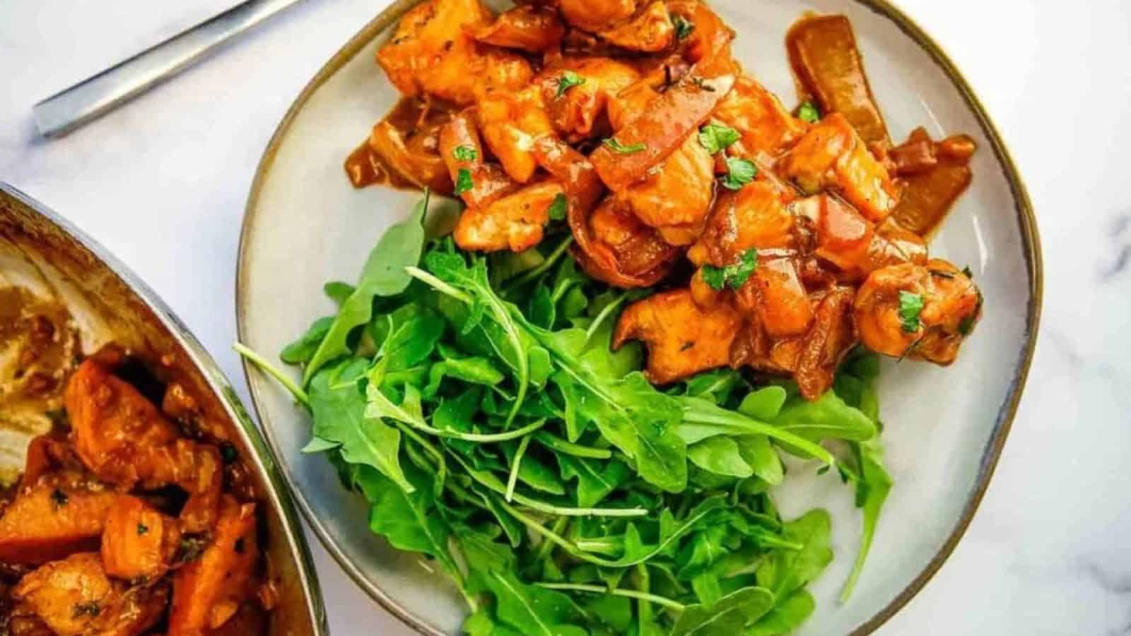 A serving of creamy balsamic chicken skillet next to a serving of green salad.