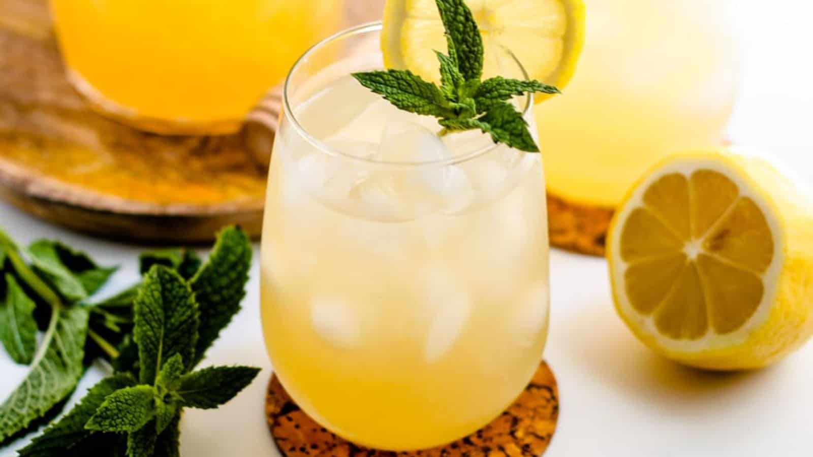 A glass of iced green tea garnished with fresh mint.