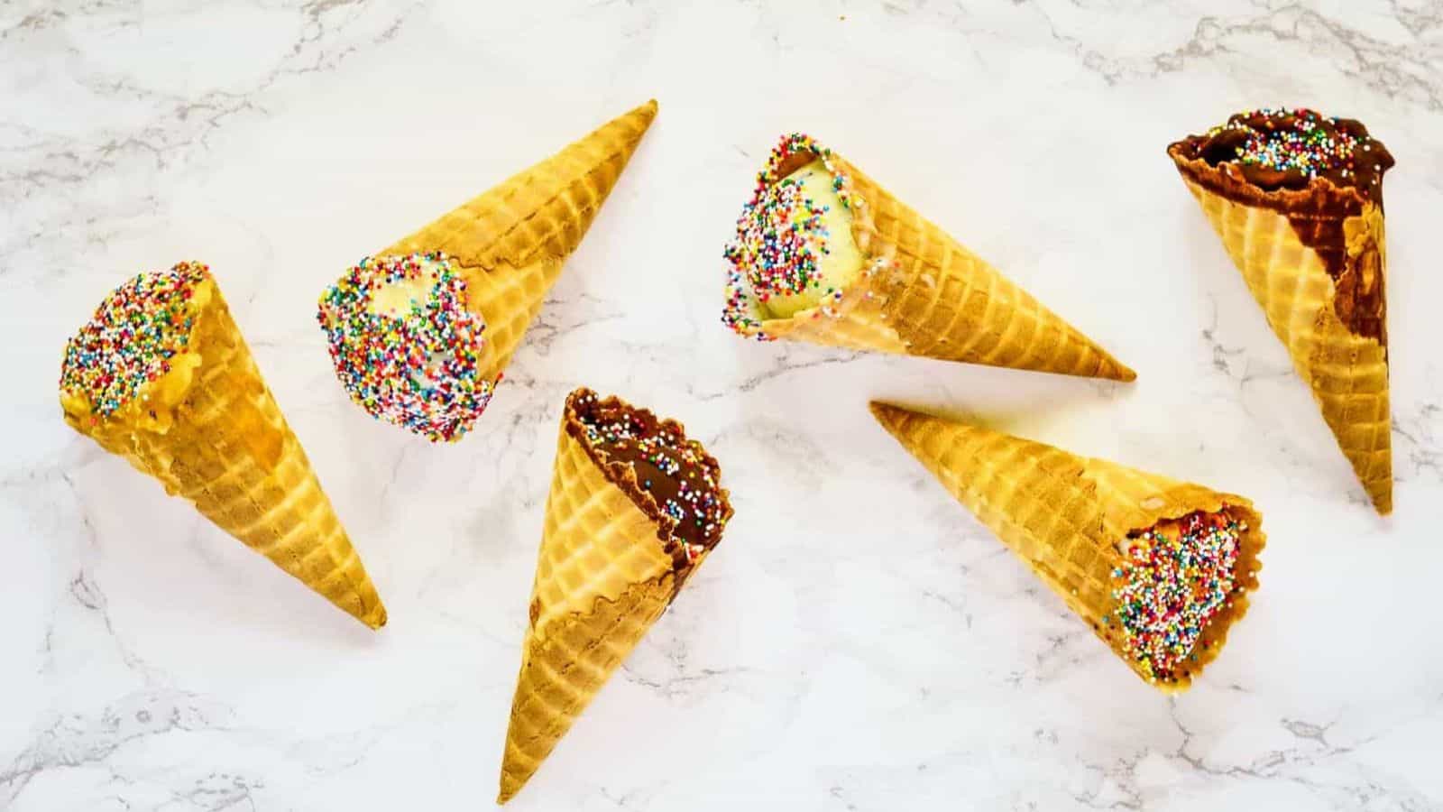 Overhead shot of 6 cones, two in chocolate, two peanut butter, two vanilla.