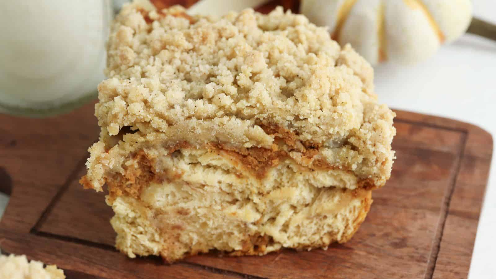 A piece of pumpkin crumb cake on a cutting board.