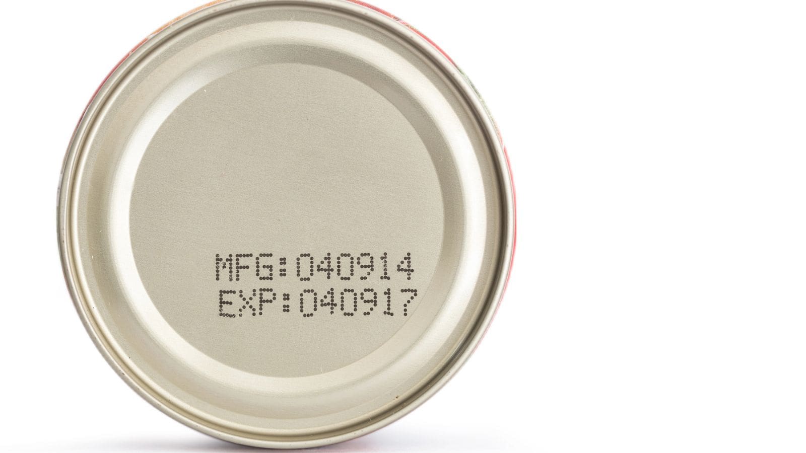 A close-up view of the top of a metal can displaying printed manufacturing and expiration dates: MFG 040314 and EXP 040917, on a plain white background.