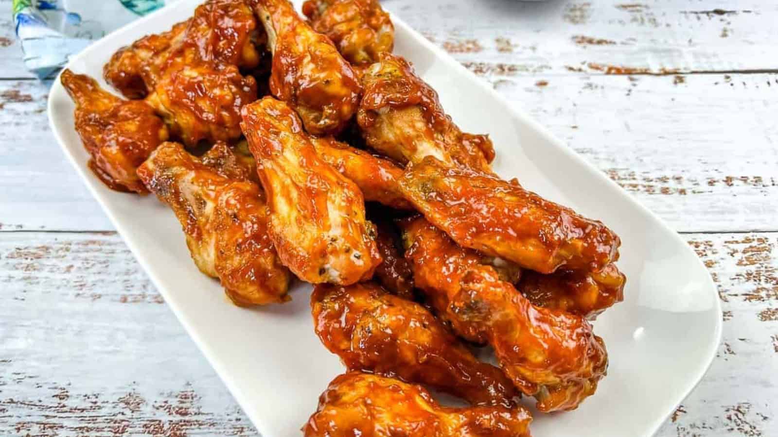 Ninja Woodfire Grill Wings with Jack Daniel's BBQ Sauce on a white plate.