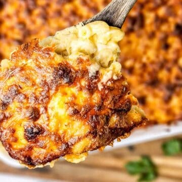 A casserole dish with cheese and corn on top.